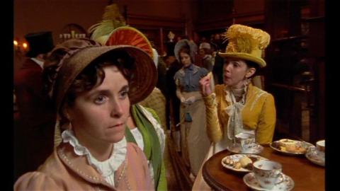 Film still from 1995 adaptation of Persuasion showing Elizabeth eating sweets. 